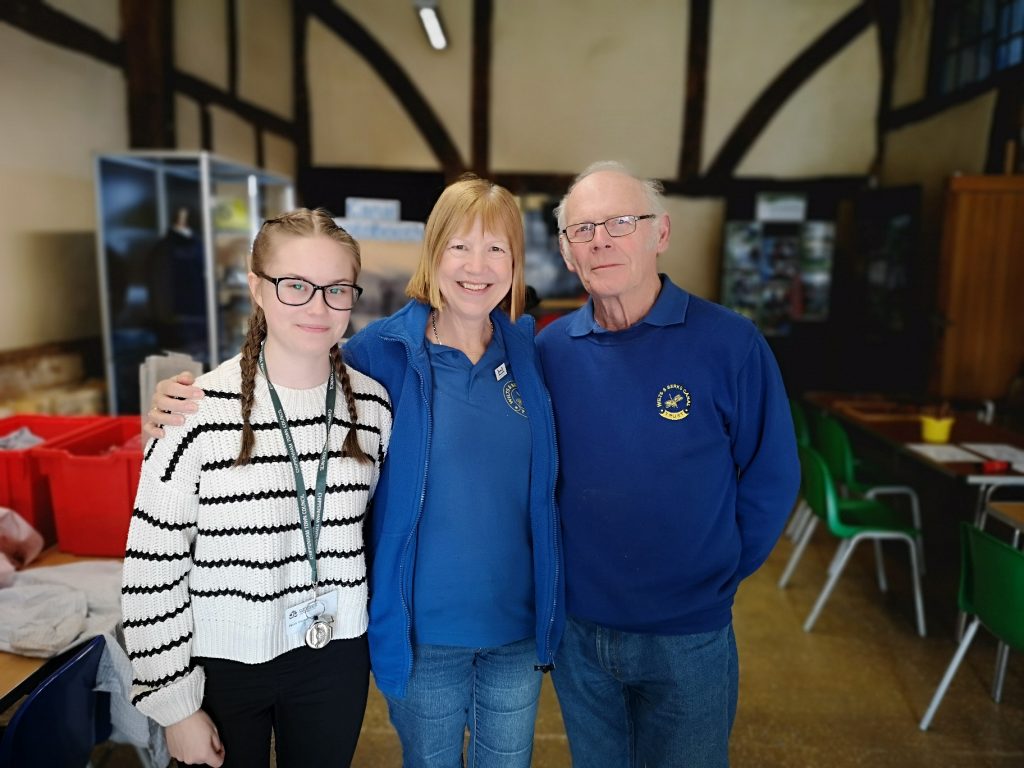 Millie standing with volunteers from the Wilts & Berks Canal Trust with activities in the background 