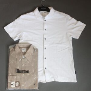 Flat lay of a white short sleeve shirt, and a brown and white pin stripe shirt in Burton plastic packaging