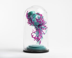 Turquoise and pink scrolled plastic sculpture in a glass dome