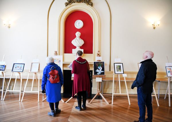 People looking at an art exhibition