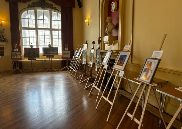 Art gallery with canvas's and paintings lined up around the room