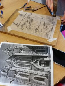 representations of local and Ukrainian buildings made in wire by workshop participants.