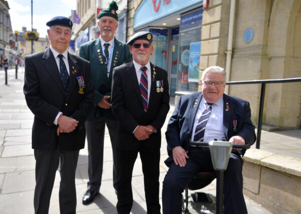 Photograph of a group of 4 men in uniform in the high street