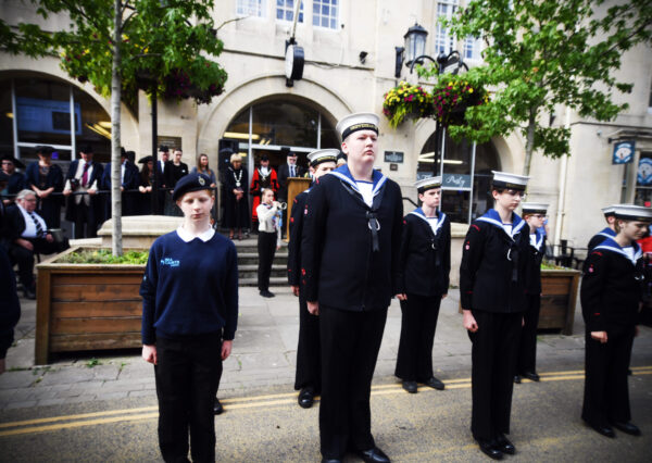 Photograph of people in uniform lined up in the high street