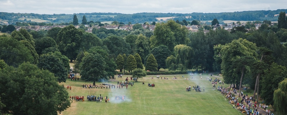 Monkton Park Header Image Photograph of people gathered at Monkton Park on the green grass