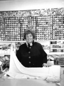 Black and white film photograph from the 2000s showing a woman in a local haberdashery. Black and white film photograph from the 2000s showing a woman in a local haberdashery.
