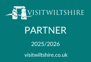 Visit Wiltshire partner logo for 2025-2026. A green, rectangular logo with white text.