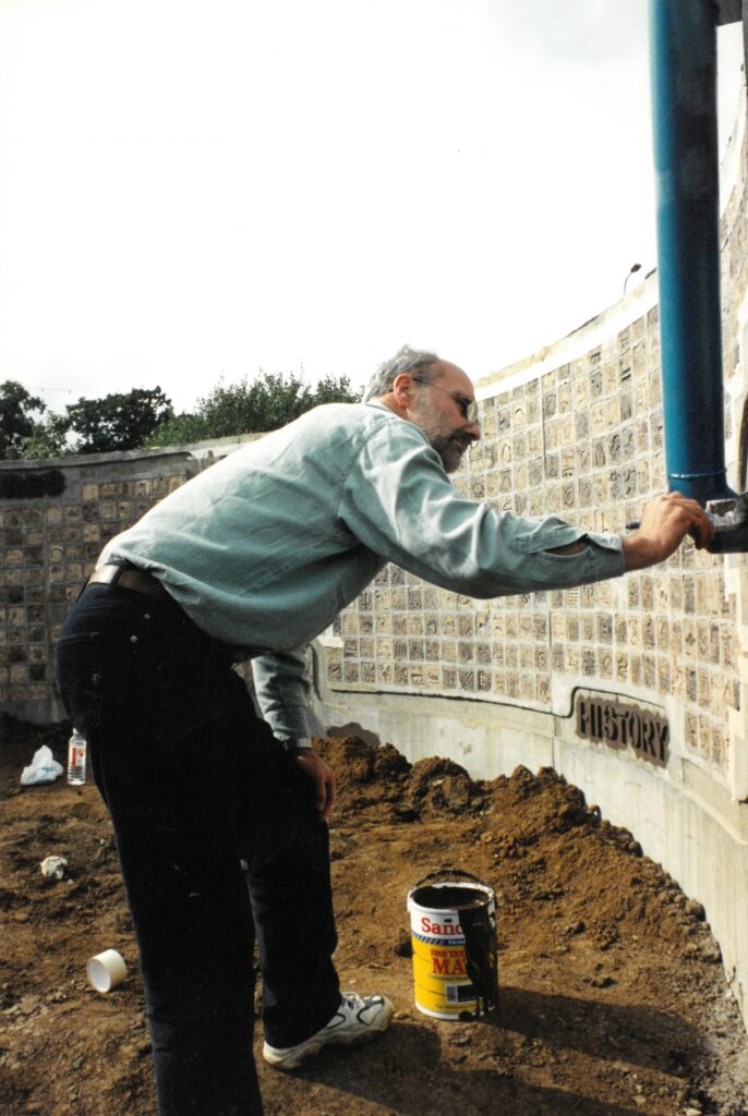 Christopher White adding the finishing touches to the tiles on the Millennium Wall.