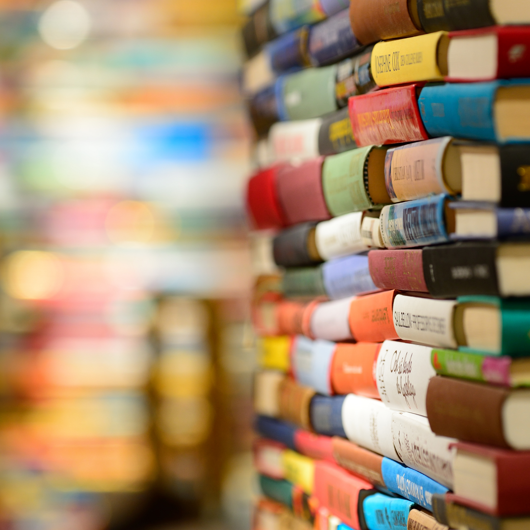 Stacks of colourful books in rows
