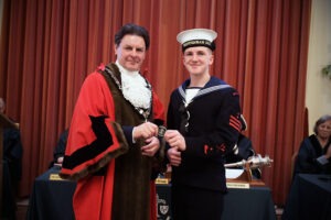 Photograph showing Mayor of Chippenham, Matthew Bragg, wearing the Mayoral Robe, presenting an award to new Mayoral Cadet Owen. Photograph showing Mayor of Chippenham, Matthew Bragg, wearing the Mayoral Robe, presenting an award to new Mayoral Cadet Owen.