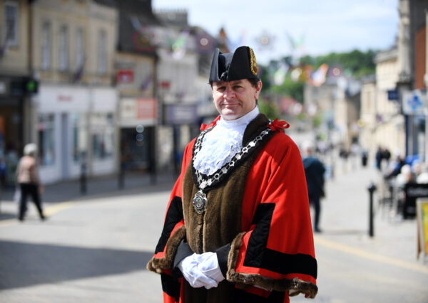 Photograph showing the Mayor of Chippenham dressed in formal civic dress robes standing in the High Street