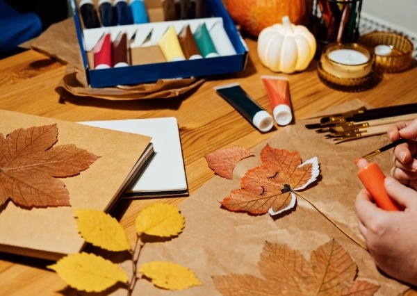 October Half Term at Chippenham Museum An image showing autumn leaves being painted.